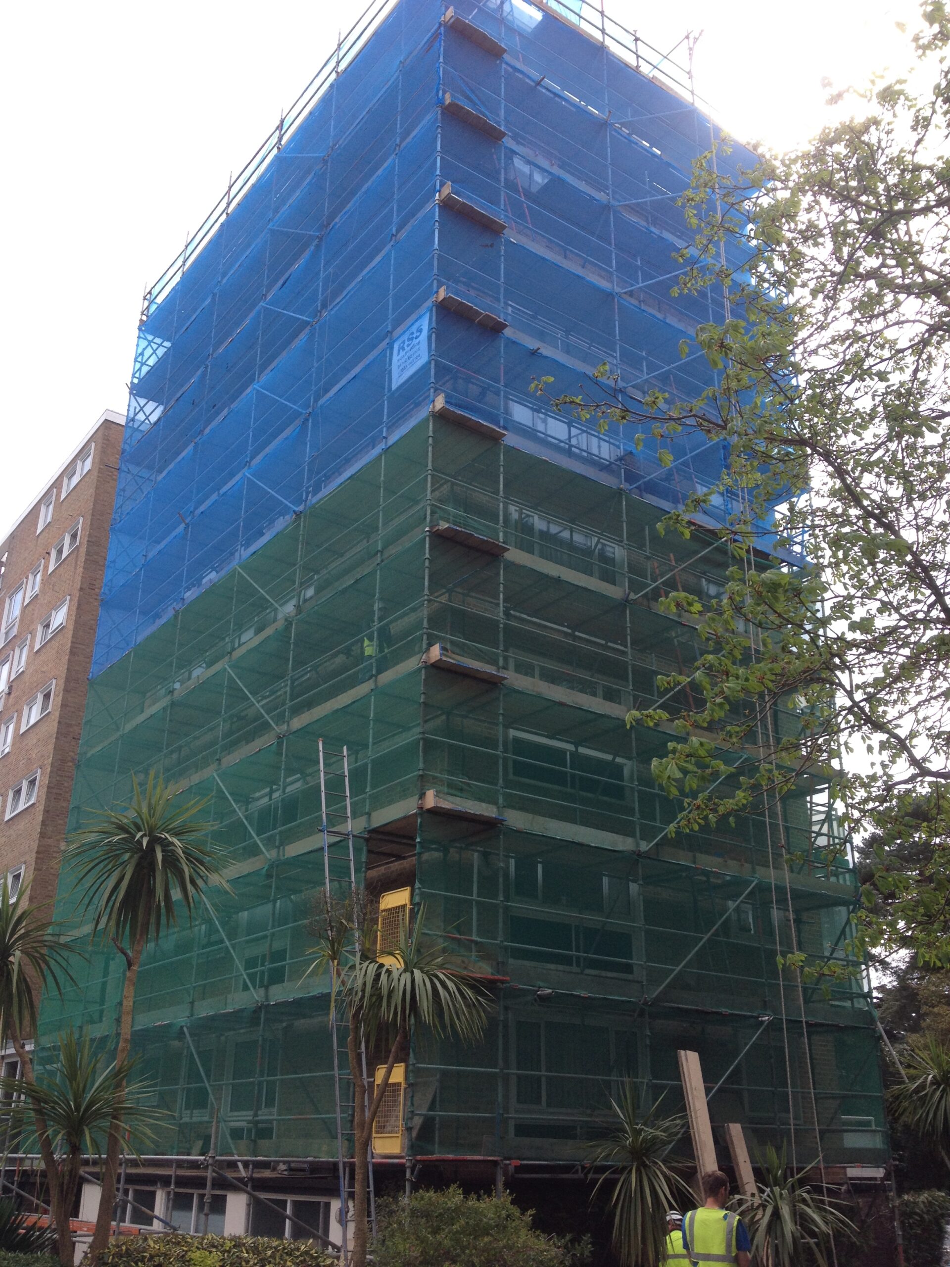Multi-story building under construction with scaffolding